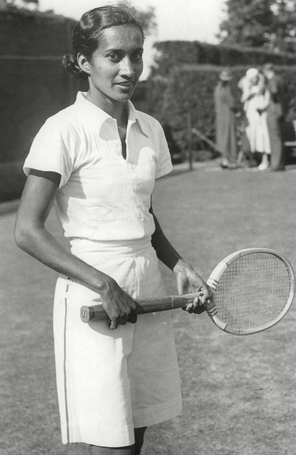 Row seen on a tennis court wearing a t-shirt and shorts