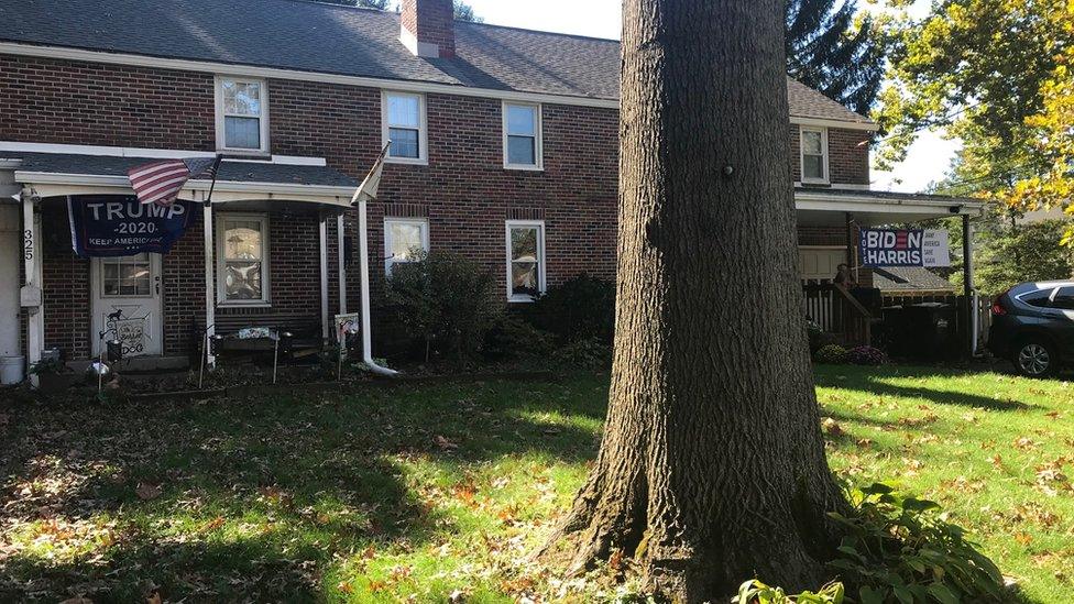 A house with a Biden sign on one side, and a Trump sign on the other