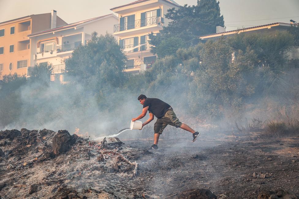 A man battles the flames in Alto do Alvide, Cascais, Portugal