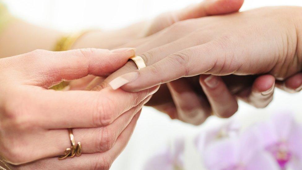 Women exchanging wedding rings