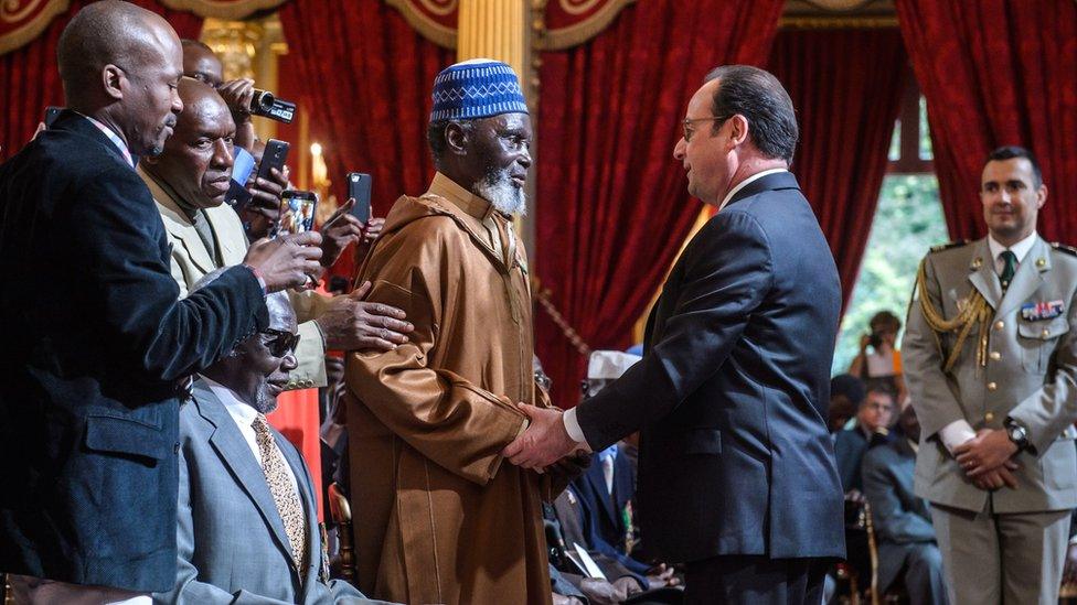 French President Francois Hollande shakes the hand of one of the veterans