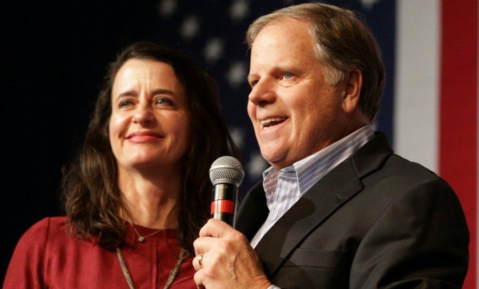 Democratic US Senate candidate Doug Jones speaks to his supporters as his wife stands by his side