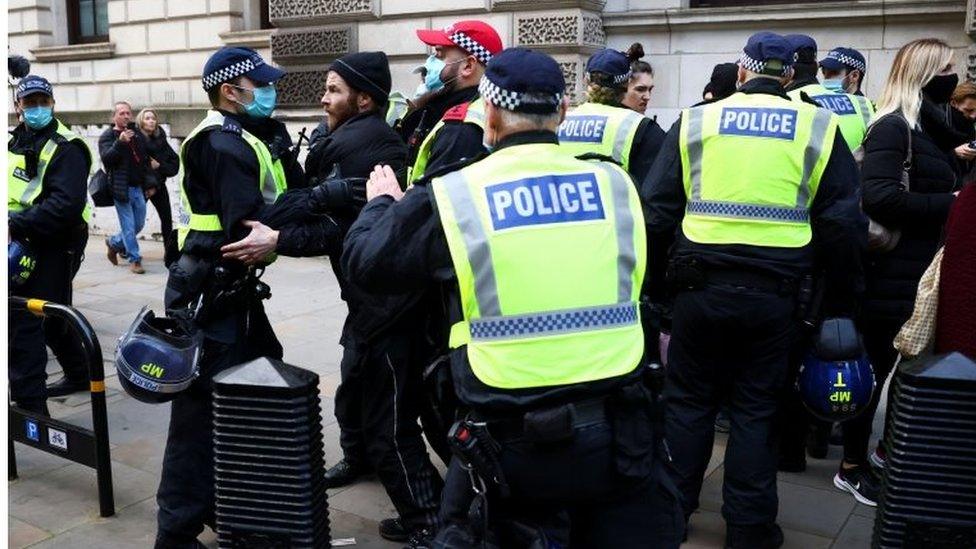 A protester being restrained by police