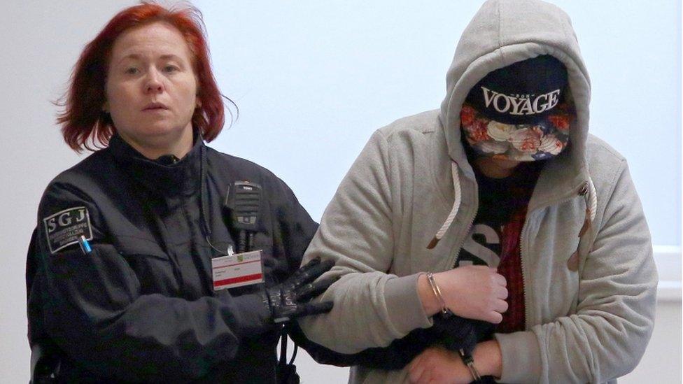 Defendant Maria K. (R) is escorted to the courtroom in handcuffs by a prison officer