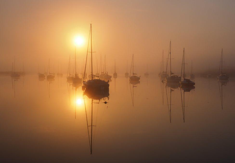 Yachts in the mist on the River Crouch at sunrise