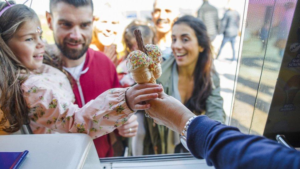 Girl getting ice cream from van