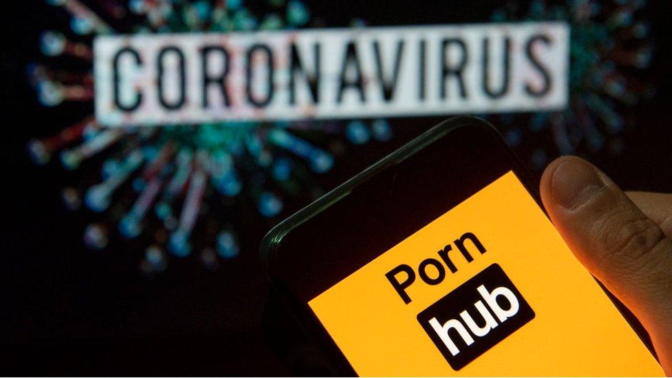 Pornhub logo on phone in front of the word cornonavirus