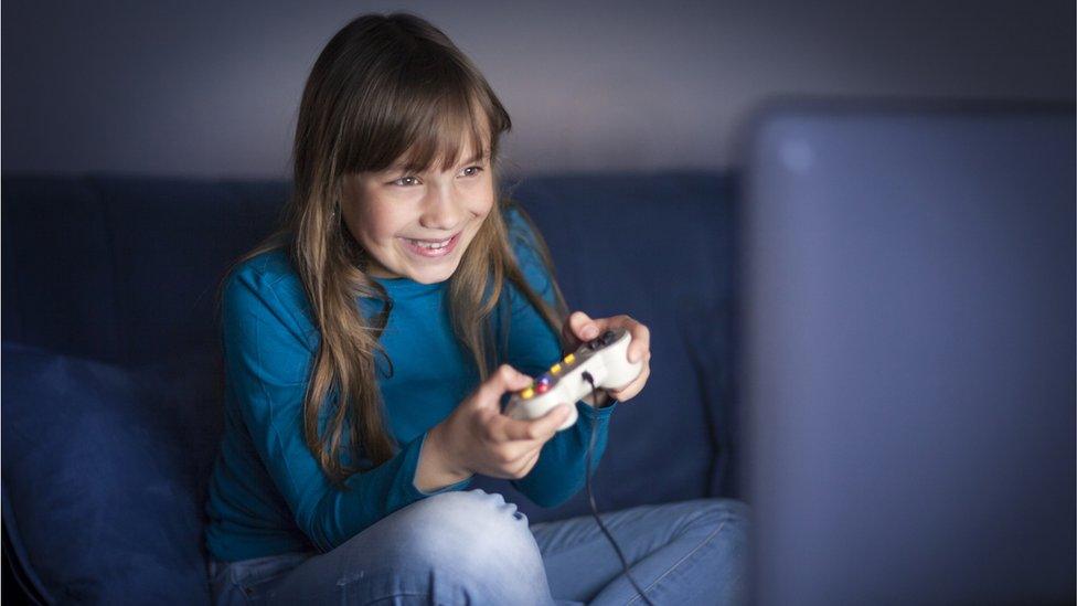 Girl-playing-games-on-sofa.