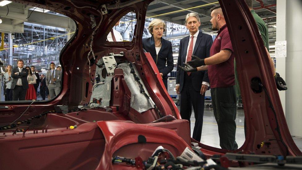 Theresa May visits a Jaguar Land Rover factory in England's West Midlands