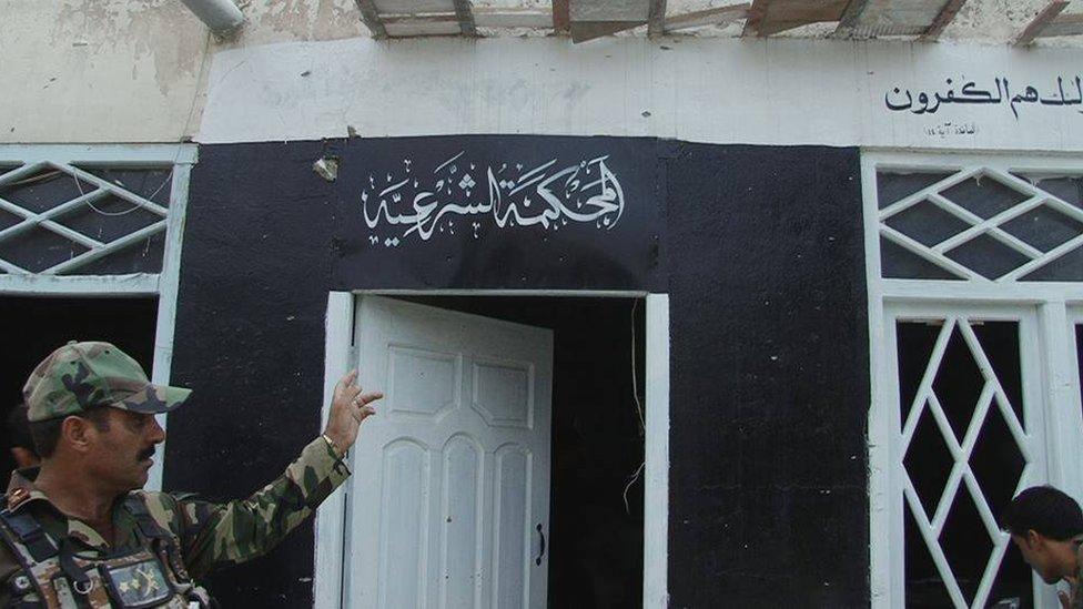 Photo released by the Nangarhar media office shows a house with the Islamic State group's flag painted on it