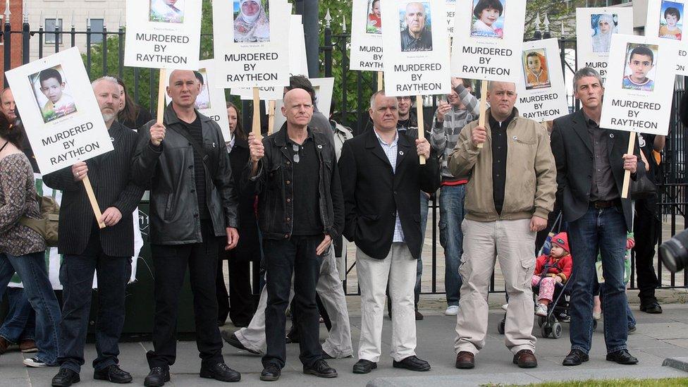 Eamonn McCann and protesters outside a court in Belfast