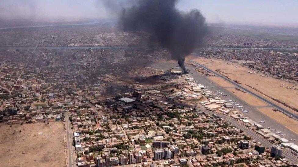 This image grab taken from AFPTV video footage on April 20, 2023, shows an aerial view of black smoke rising above the Khartoum International Airport amid ongoing battles between the forces of two rival generals