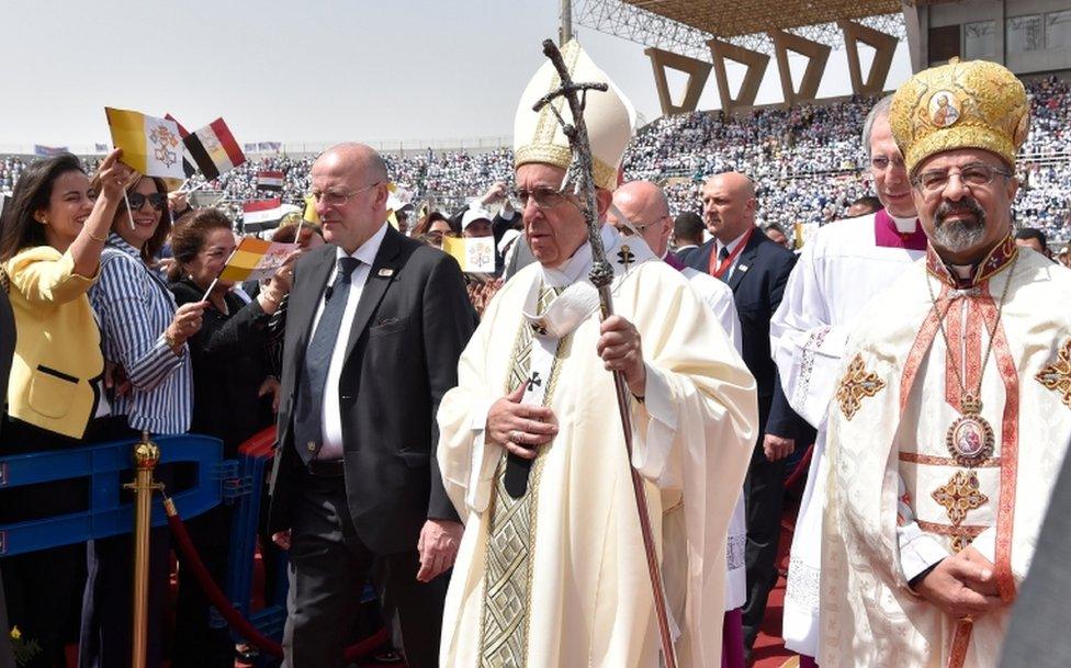 Pope Francis (C) and Coptic Patriarch of Alexandria, Ibrahim Isaac Sidrak (R) during a mass at the stadium of Cairo, on April 29, 2017