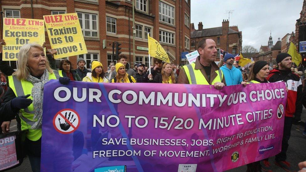 Protesters march across the city behind a large banner on February 18, 2023 in Oxford, England