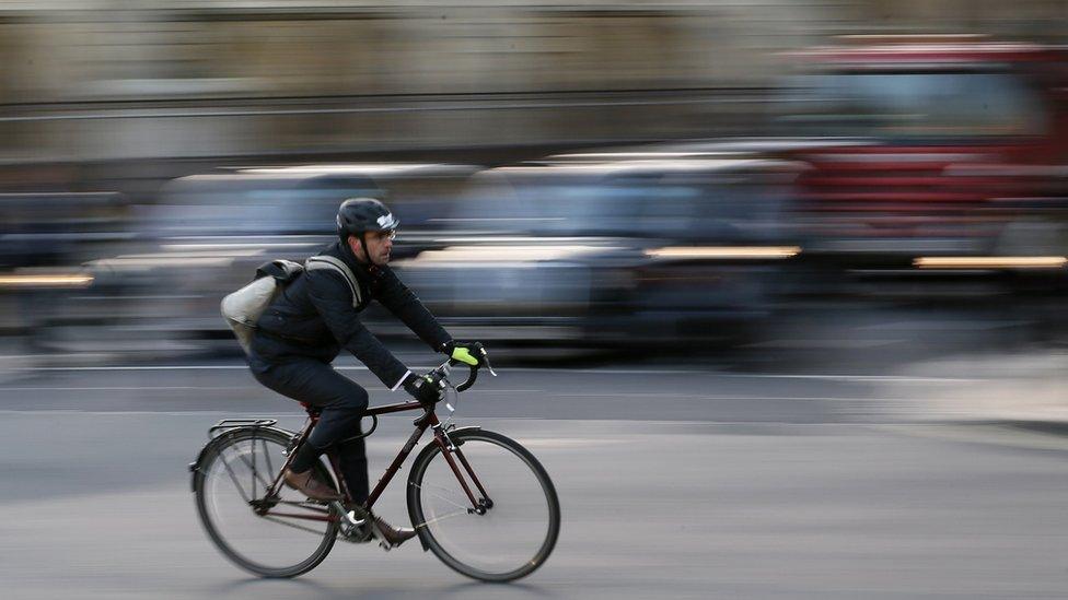 A Commuter cycles in central London November 15, 2013.