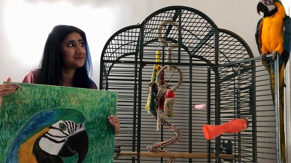 Kitty Kaur with an image of her parrot Rio