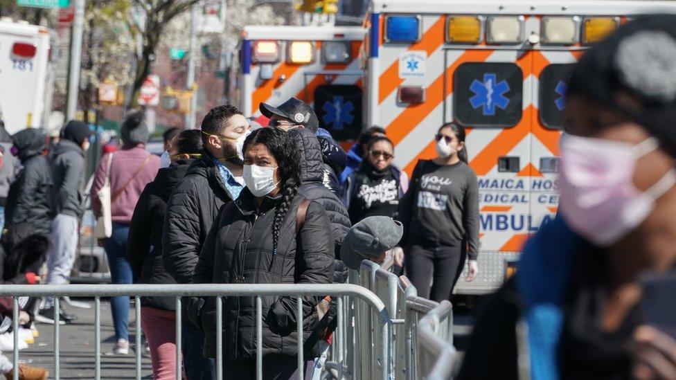 People wait in line to receive a Coronavirus test at Elmhurst Hospital in the Borough of Queens, in New York