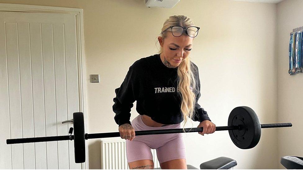 Aimee lifting a bar-bell