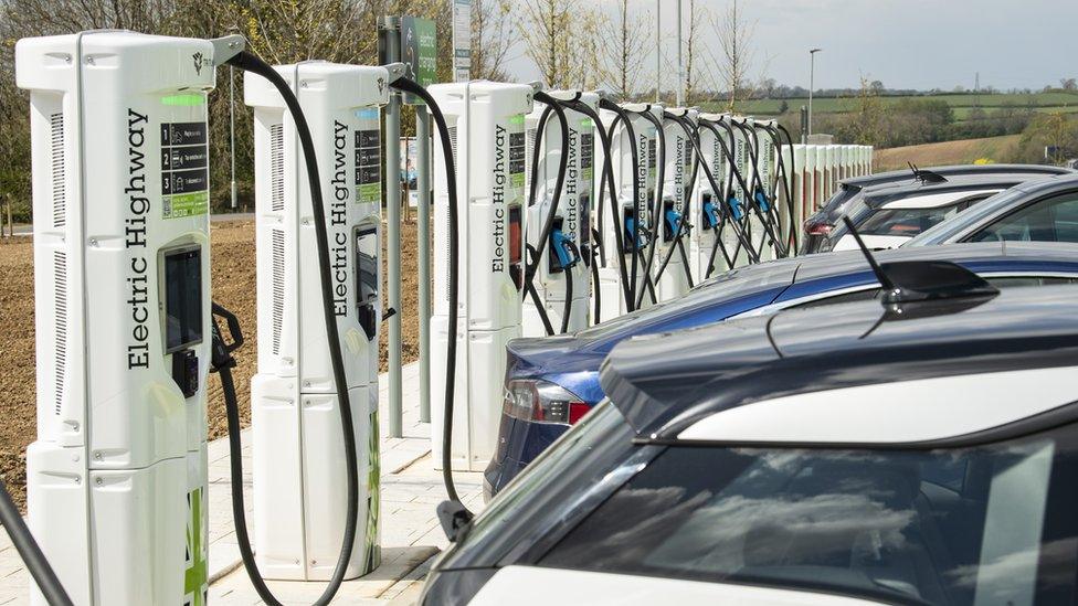 Multiple charge points are provided in a row for electric vehicles at the first 'Electric Hub' at Rugby services