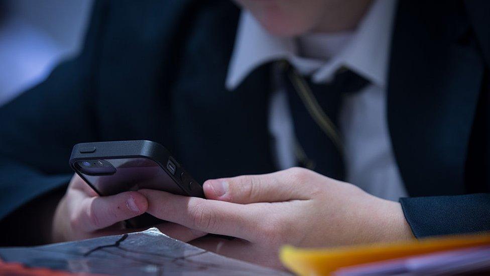 School pupil will a mobile phone