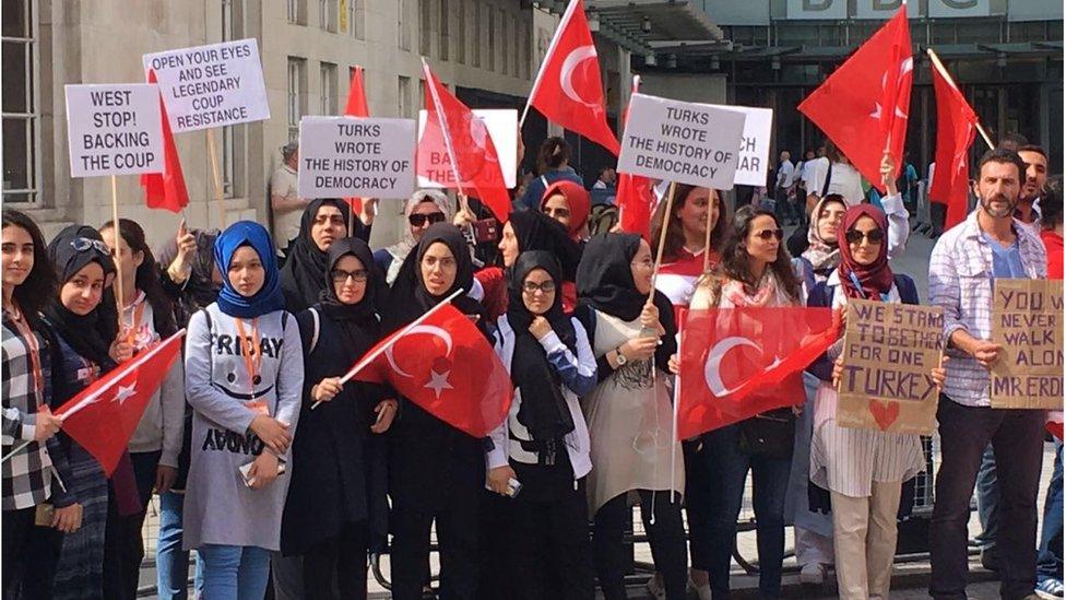 A group of Turkish students who live in London hold banners reading 'West stop! backing the coup', 'Open your eyes and see legendary coup resistance', 'You will never walk alone Mr. Erdogan' as they gather in front of the headquarters of British Broadcasting Corporation on