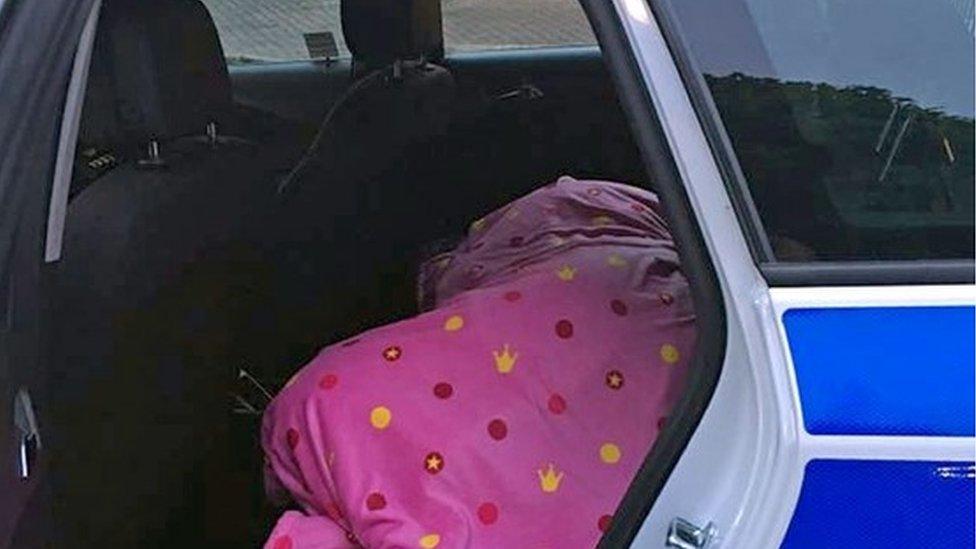 Katie Simpkins asleep in police car