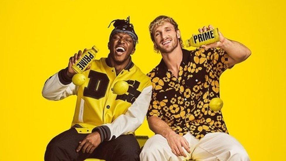 KSI and Logan Paul holding PRIME bottles