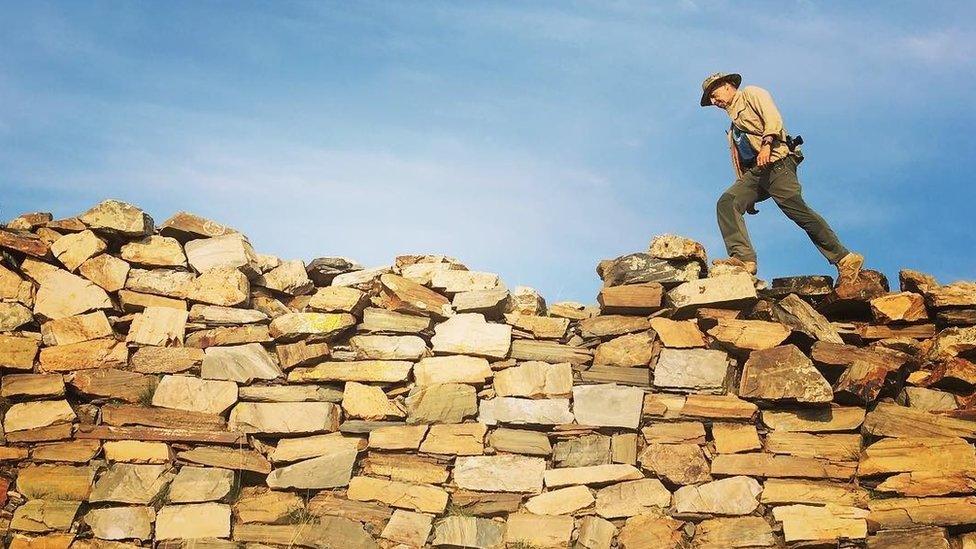 Treading on piled-up stones that became the first component of the now famous Great Wall, originally dating from the late 4th century BC, Inner Mongolia