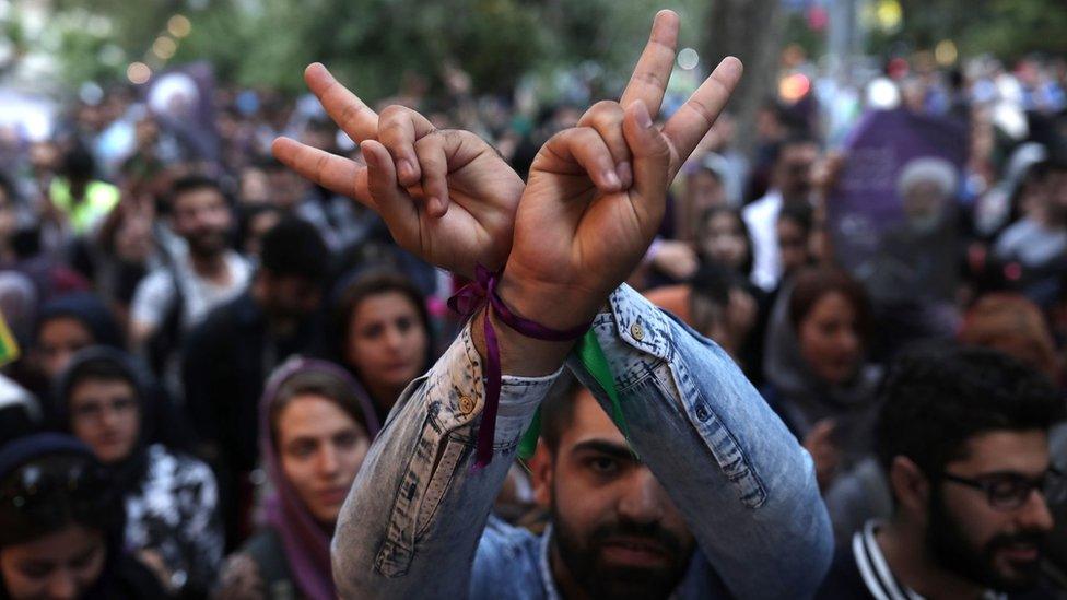 Supporter of Iranian President Hassan Rouhani flashes victory sign to celebrate victory. Tehran, May 20, 2017