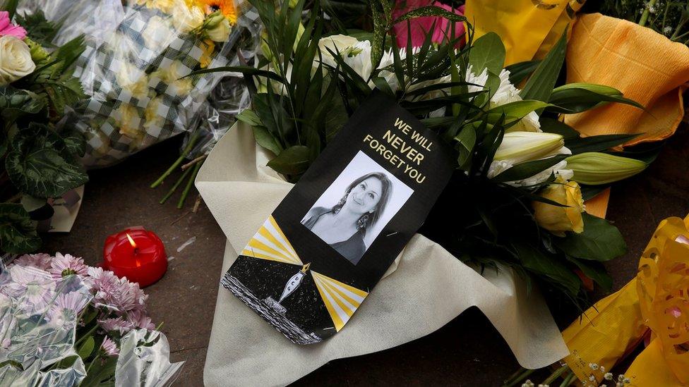 Candles and flowers are seen at an impromptu memorial during a protest by journalists