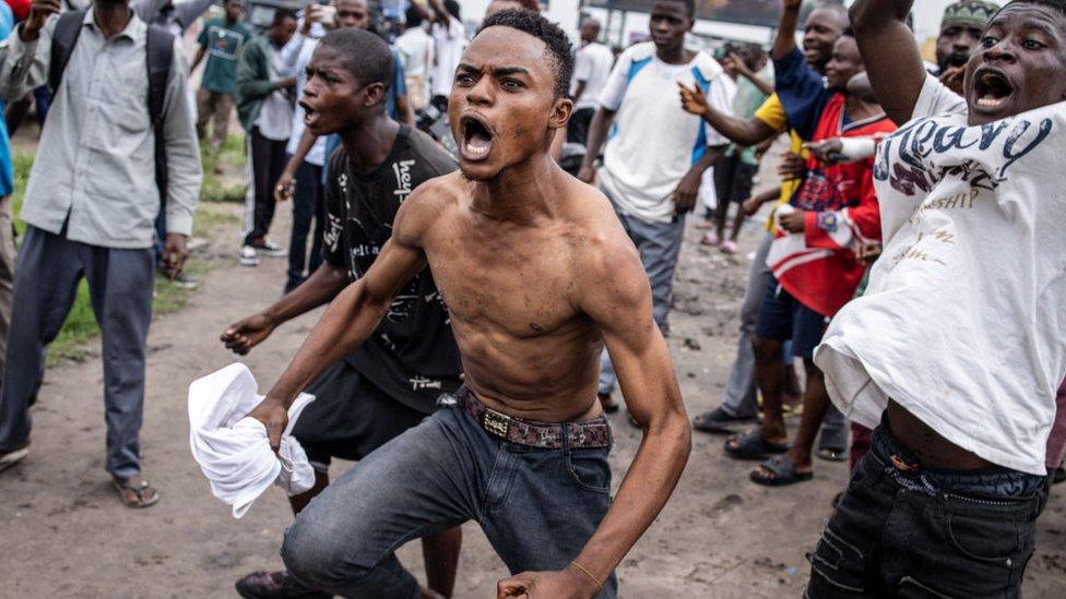 A supporter of opposition leader Martin Fayulu gestures during a demonstration in Kinshasa on December 27, 2023