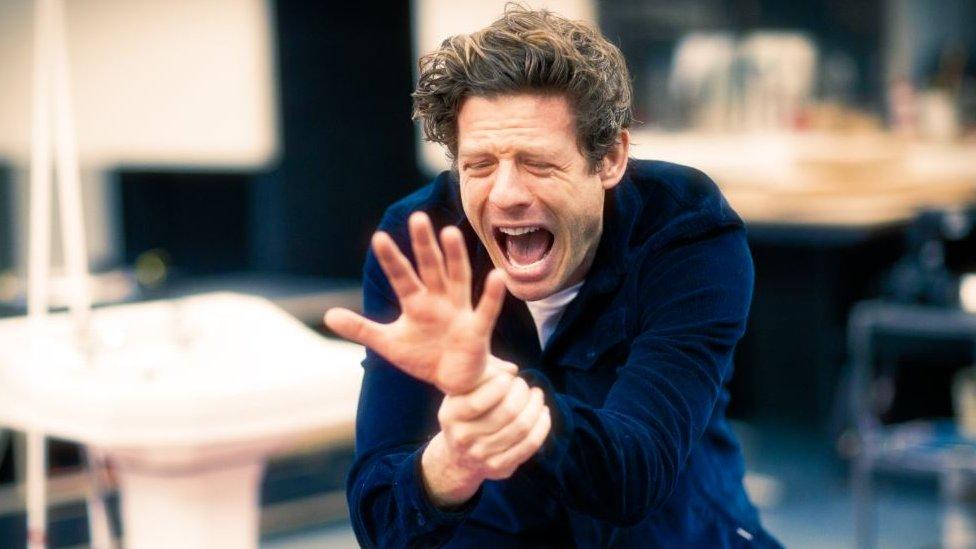 James Norton holding his wrist in pain in A Little Life