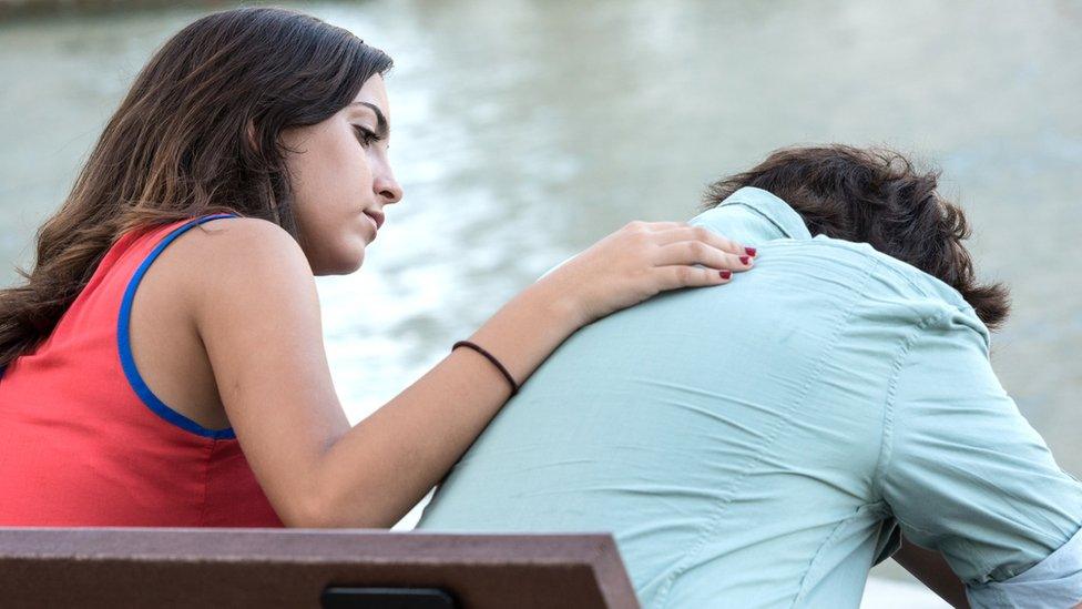 Boy being comforted.