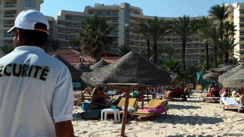 Tourists enjoy the beach near a four-star hotel in the resort town of Sousse on October 31, 2013