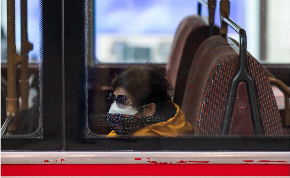 A passenger wearing a face mask rides bus on Oxford Street on March 19, 2020 in London, England. Transport for London announced the closure of up to 40 tube stations as officials advised against non-essential travel. Bus and London Overground service will also be reduced. (Photo by Dan Kitwood/Getty Images)