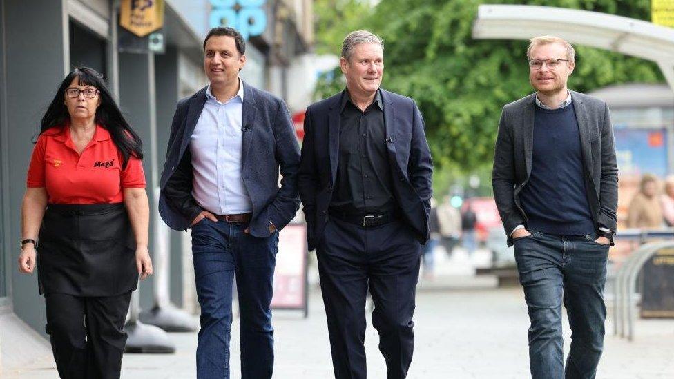 Labour leader Sir Keir Starmer with Scottish Labour leader Anas Sarwar and Labour candidate for the Rutherglen and Hamilton West by-election Michael Shanks (right) during a visit to to meet business owners and voters