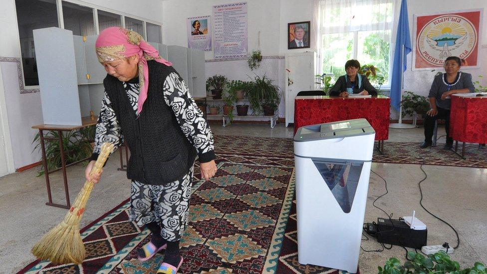 A woman sweeping up before election day at a polling station in the village of Tash-Moynok, some 20km outside Bishkek