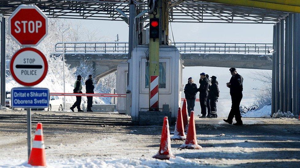 Kosovo and Serbian police stand at the Kosovo-Serbia border crossing of Merdare on December 10, 2012.