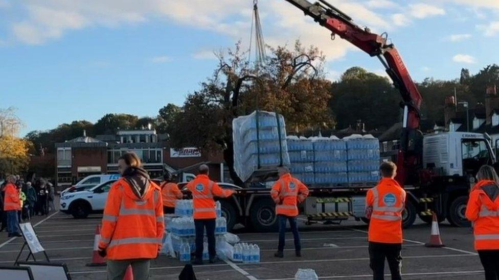 A bottles water station taking a delivery of water