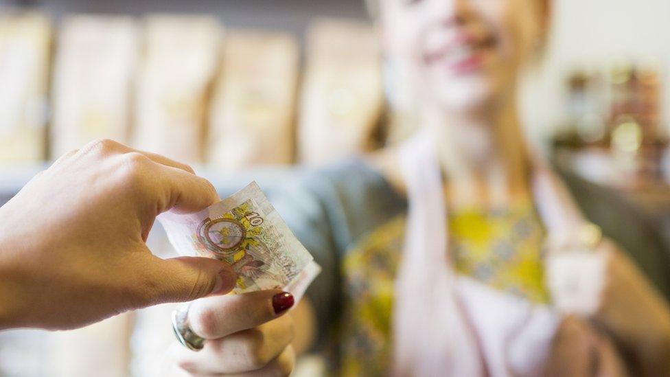 Person paying with cash