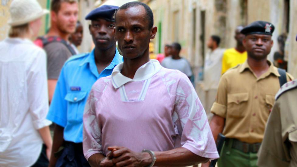 Ali Kololo, a former employee of the Kiwayu Safari Village, is escorted by police, July 2013