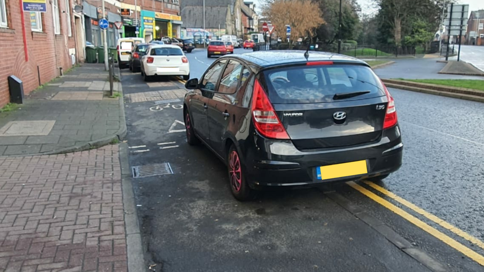 Cars parked on the pavement