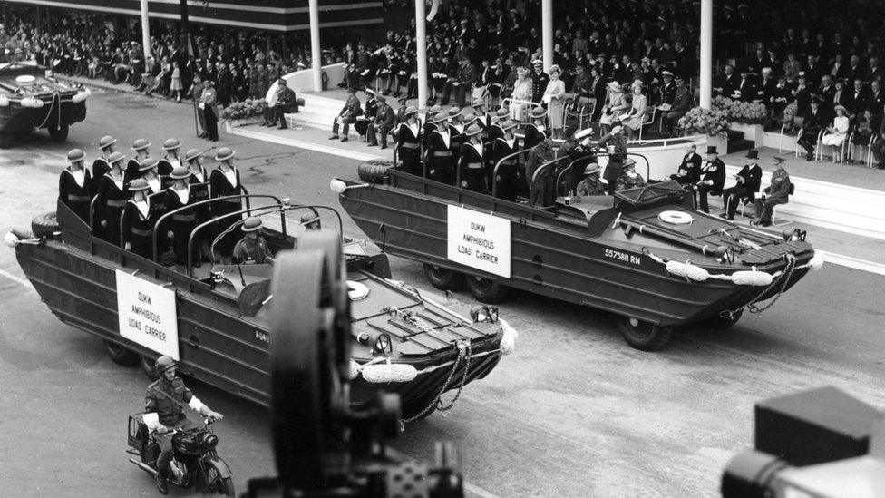 Amphibious Load Carriers (ducks or DUKW) of the Royal Navy passing the Saluting Base. In the further one is Lt. Peter Scott, who described the progress of the mechanised procession, in the BBC broadcast of the Victory March. A completed sound picture parade was broadcast by the BBC.