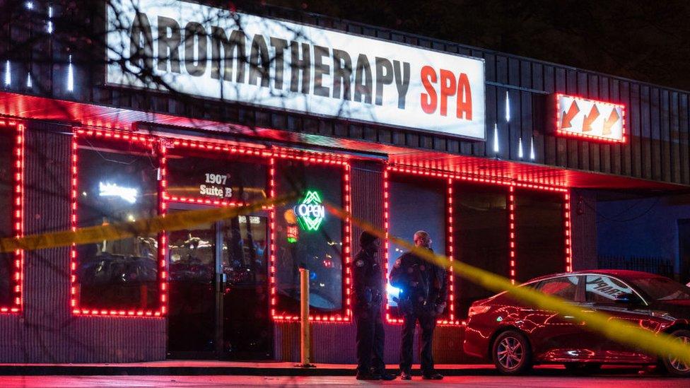 Law enforcement personnel are seen outside a massage parlour where a person was shot and killed on March 16, 2021, in Atlanta, Georgia