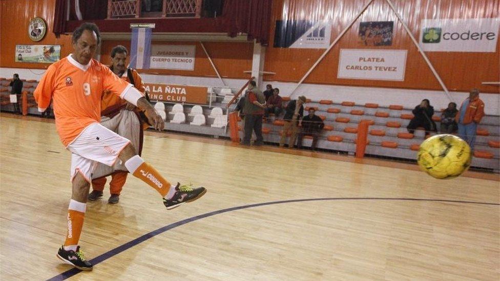 Daniel Scioli kicks the ball before an indoor soccer match in Buenos Aires on 17 October, 2015.