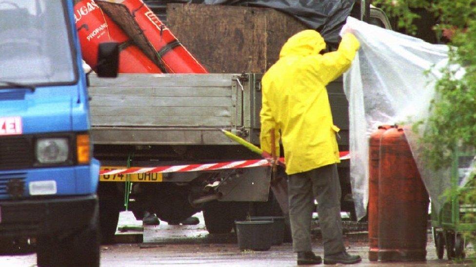 A British military policeman inspects a part of the bomb at the Army base in Osnabrueck in 1996