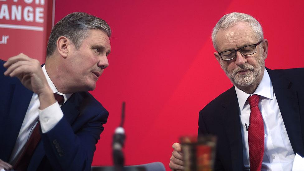 Sir Keir Starmer and then-Labour leader Jeremy Corbyn talk onstage during a campaign speech on December 6, 2019 in London