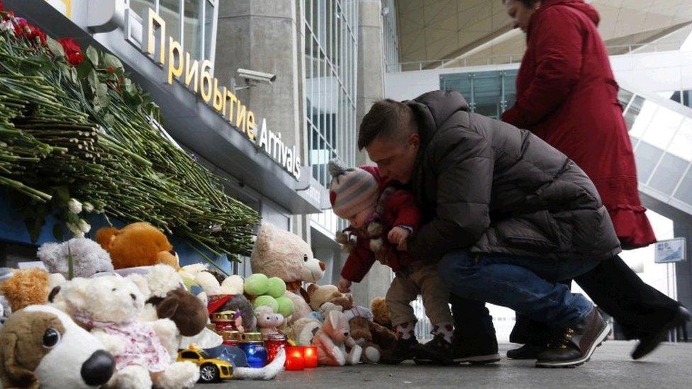 People lay flowers and toys at an entrance of Pulkovo airport outside St.Petersburg, Russia, during a day of national mourning for the plane crash victims, on Sunday, Nov. 1, 2015.