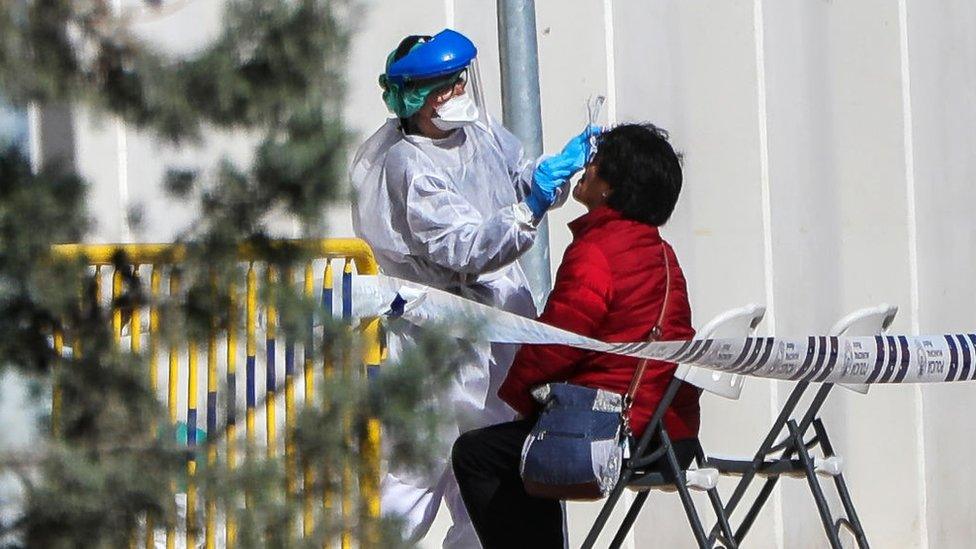 A woman is tested for coronavirus in Spain