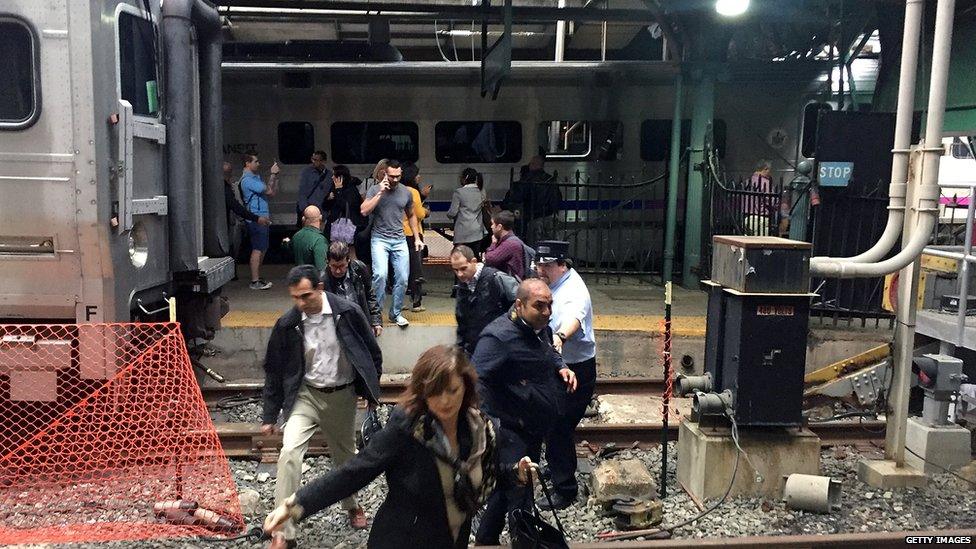 Passengers evacuate after a train crashed into the platform at the Hoboken Terminal on 29 September 2016.